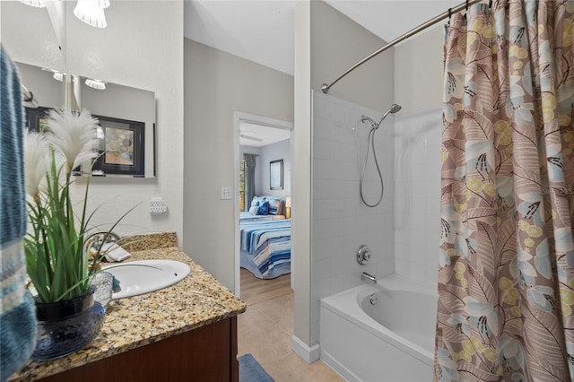 bathroom with tile patterned flooring, vanity, and shower / tub combo