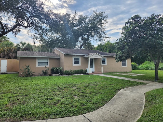 ranch-style home with a front lawn