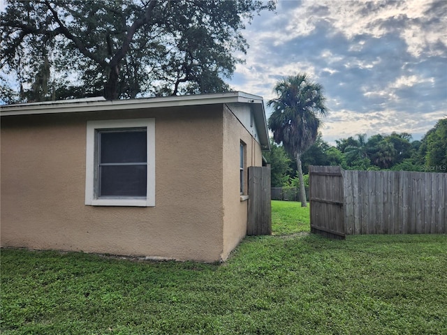 view of side of property with a lawn