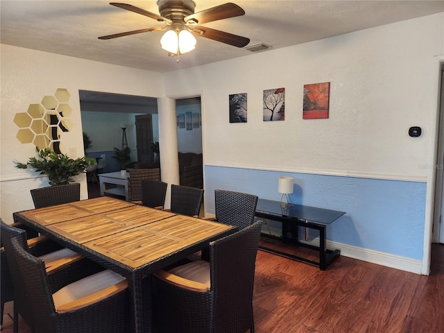 dining area with ceiling fan and dark hardwood / wood-style floors