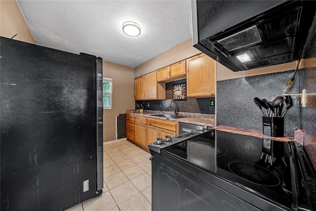 kitchen featuring black appliances, light tile patterned floors, sink, and extractor fan