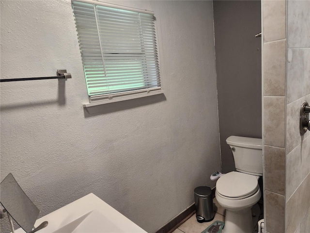 bathroom with tile patterned flooring and toilet