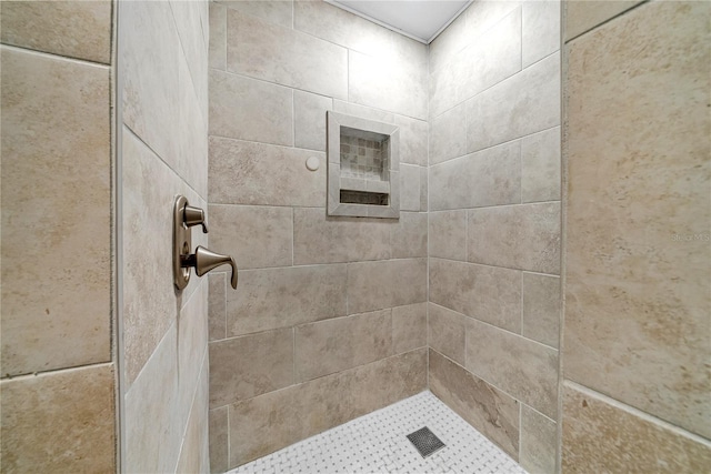 bathroom with tiled shower