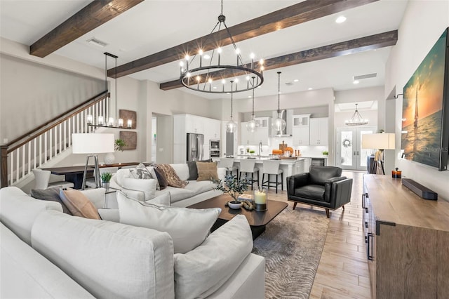 living room featuring light hardwood / wood-style floors and beamed ceiling