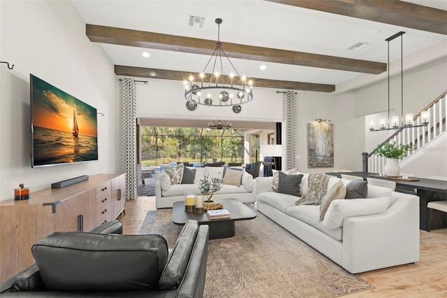 living room with light wood-type flooring, beamed ceiling, and an inviting chandelier