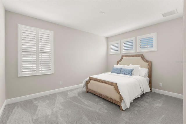 bedroom featuring light colored carpet