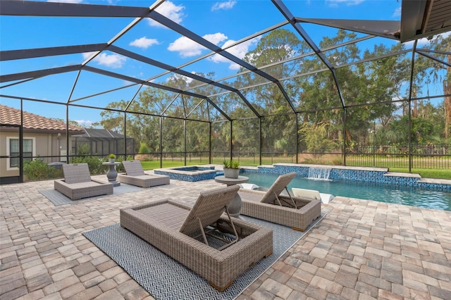 view of patio with glass enclosure, a pool with hot tub, and pool water feature