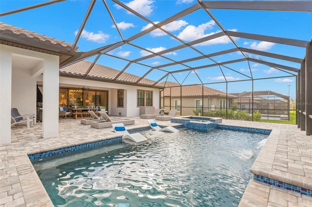 view of swimming pool featuring a lanai, a patio, and an in ground hot tub