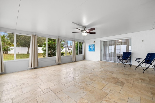 unfurnished sunroom featuring plenty of natural light and ceiling fan