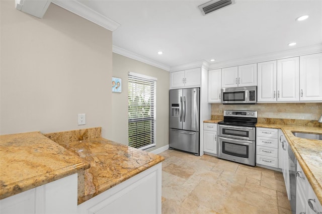 kitchen with white cabinets, kitchen peninsula, stainless steel appliances, and light stone countertops