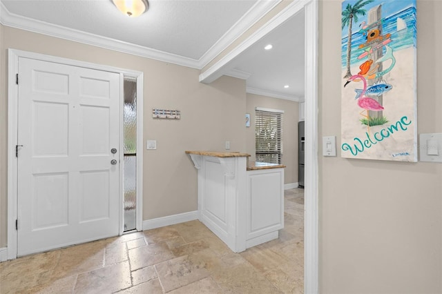 foyer entrance featuring ornamental molding