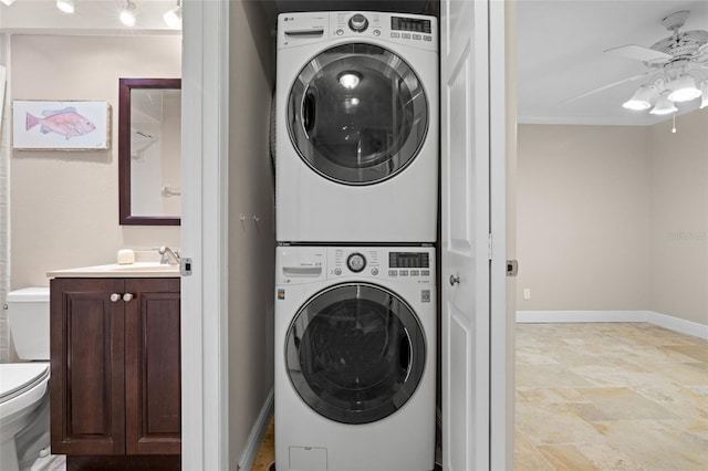 clothes washing area with ornamental molding, ceiling fan, and stacked washer / drying machine