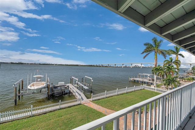 dock area featuring a water view and a lawn