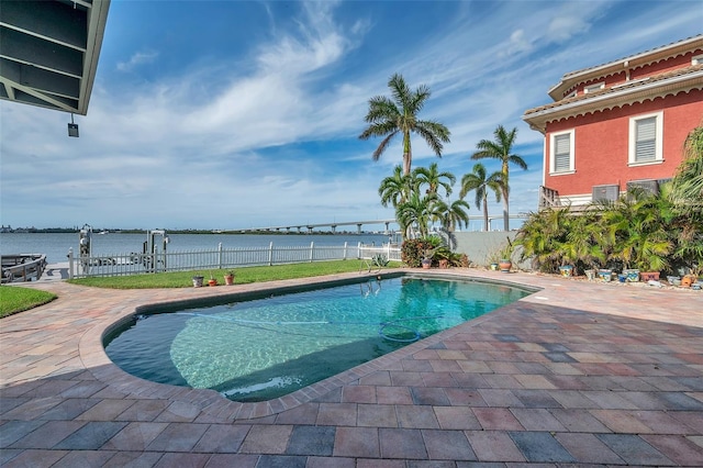 view of swimming pool with a water view and a patio