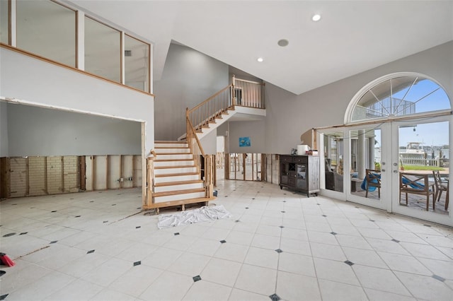 entrance foyer featuring a towering ceiling and french doors