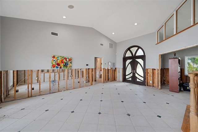 foyer featuring high vaulted ceiling