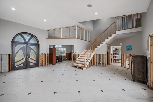 entrance foyer with a high ceiling and french doors