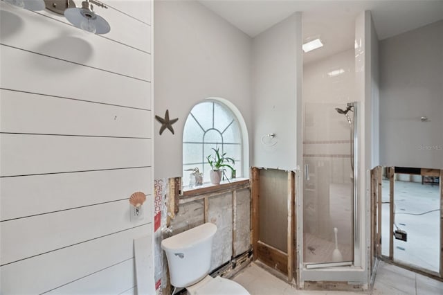 bathroom featuring walk in shower and toilet