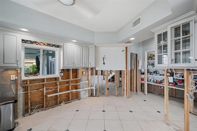 interior space featuring light tile patterned floors and white cabinets