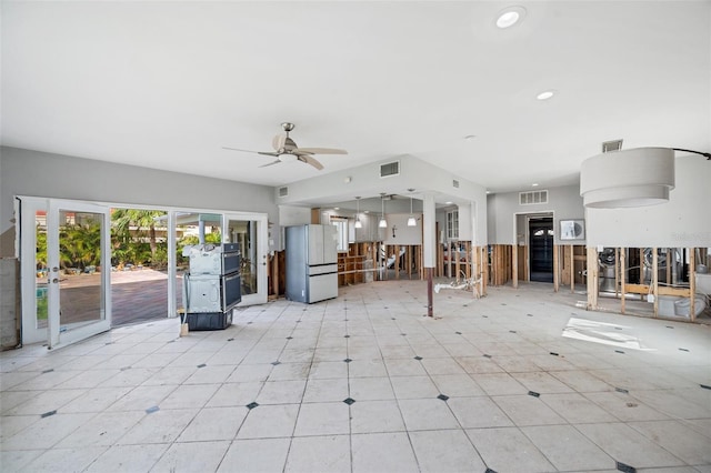 unfurnished living room featuring ceiling fan