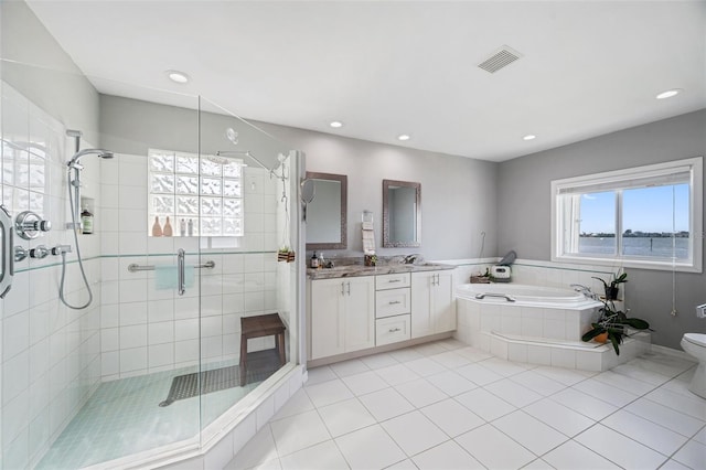 full bathroom featuring toilet, tile patterned flooring, vanity, and separate shower and tub