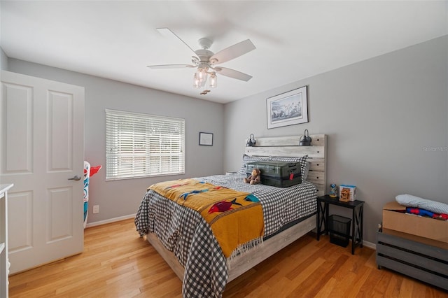 bedroom with ceiling fan and light hardwood / wood-style floors