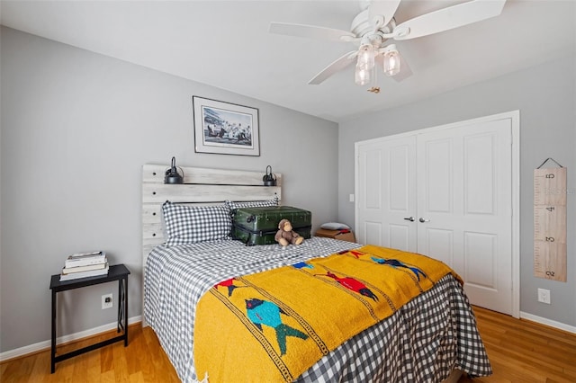 bedroom featuring light hardwood / wood-style floors, ceiling fan, and a closet