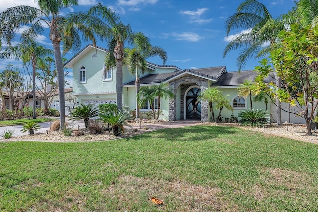 view of front facade with a garage and a front lawn