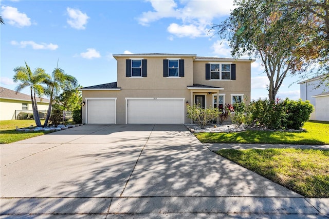 view of front of home with a garage and a front lawn