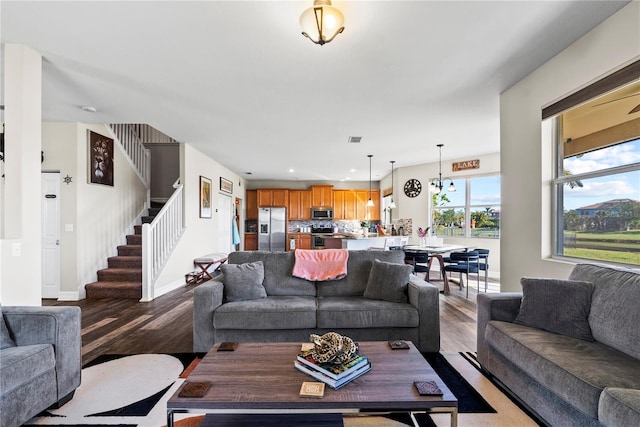 living room featuring an inviting chandelier and light hardwood / wood-style flooring