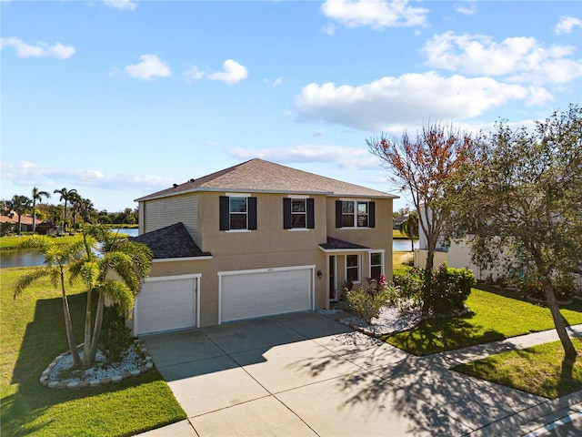 front facade featuring a front yard, a water view, and a garage