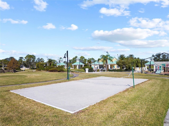 view of basketball court featuring volleyball court and a yard