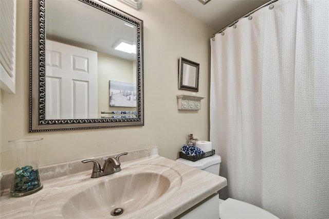 bathroom featuring vanity, a shower with shower curtain, and toilet