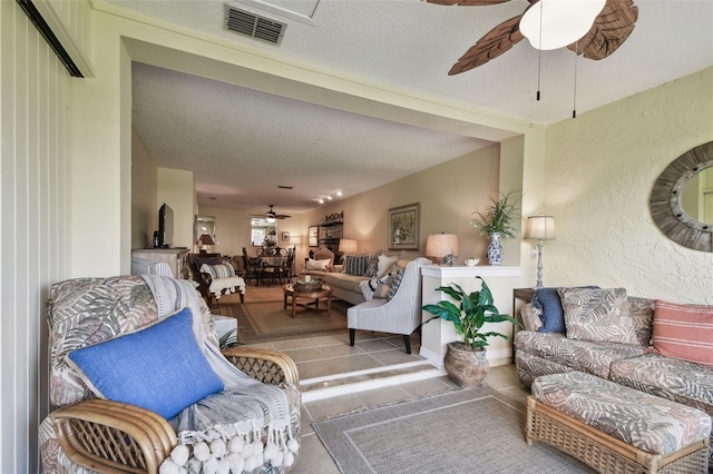 tiled living room with a textured ceiling