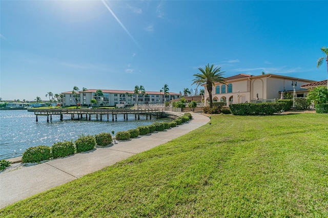 view of dock featuring a yard and a water view