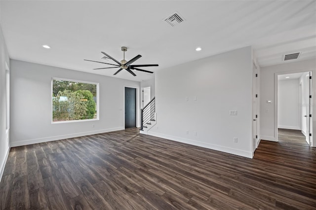 unfurnished living room featuring ceiling fan and dark hardwood / wood-style floors