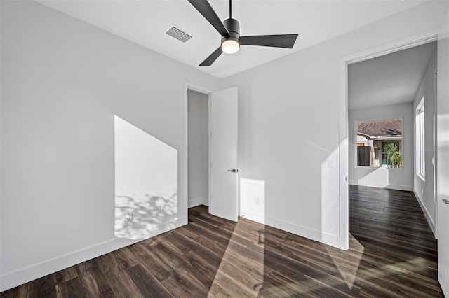 unfurnished room featuring dark hardwood / wood-style floors and ceiling fan