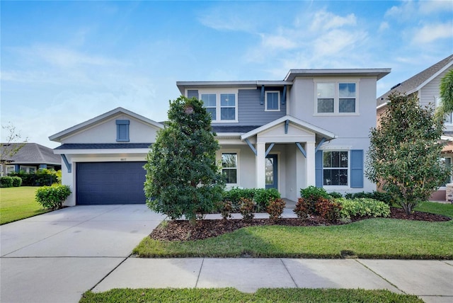 view of front of property featuring driveway, a front lawn, and stucco siding