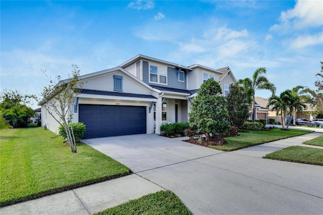 traditional-style home featuring a garage, driveway, a front lawn, and stucco siding