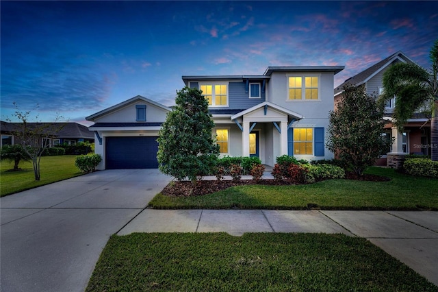 view of front of property with a garage and a yard