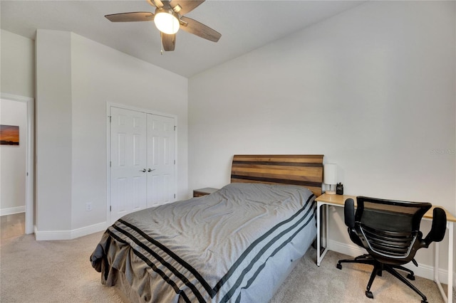 carpeted bedroom with ceiling fan and a closet