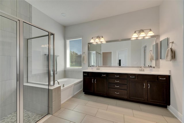 bathroom with vanity and shower with separate bathtub