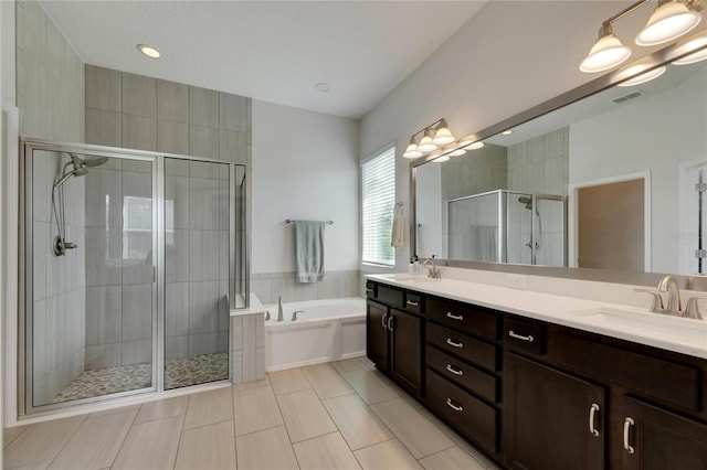 bathroom with tile patterned flooring, vanity, separate shower and tub, and tile walls