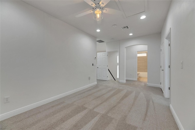 carpeted spare room featuring ceiling fan