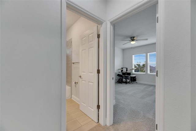 corridor featuring light colored carpet