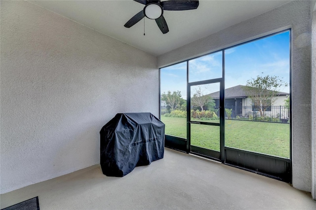 sunroom / solarium featuring ceiling fan