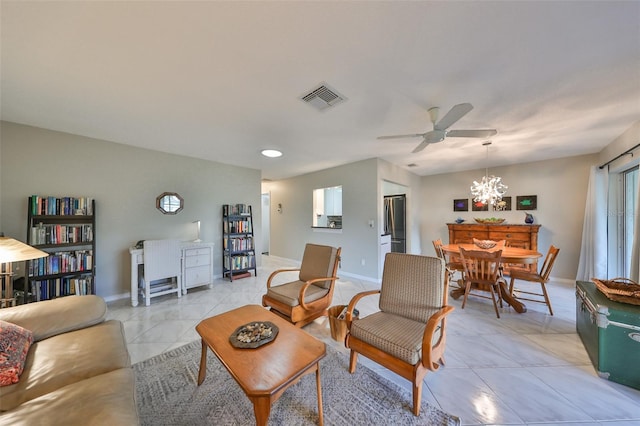 living room featuring ceiling fan with notable chandelier