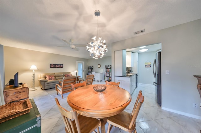 dining area featuring ceiling fan with notable chandelier and light tile patterned floors