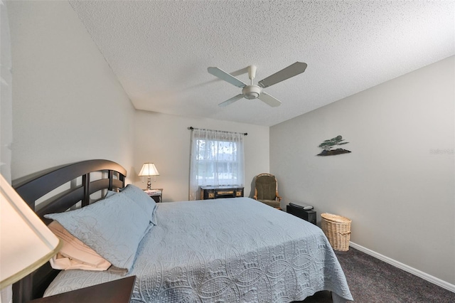 carpeted bedroom featuring ceiling fan and a textured ceiling