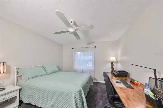 carpeted bedroom with ceiling fan and a textured ceiling